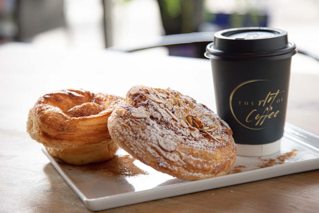 Pastries and coffee in a to-go coffee cup
